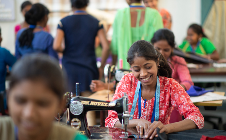 Kokan Kala Va Shikshan Vikas Sanstha's programs are dedicated to Empowering Rural Women, as depicted in the inspiring image of skilled and empowered women tailors from rural villages, symbolizing success and resilience.