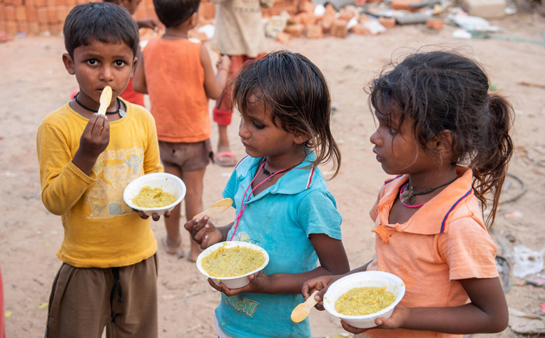 Image representing Kokan Kala Va Shikshan Vikas Sanstha's language of hope through food distribution to underprivileged children.